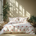 Cherry-patterned bedding set on a bed with plants and sunlight in the background