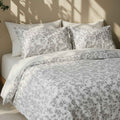 Floral patterned bedding set on a bed with a neutral background