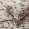 Floral patterned fabric with black flowers on a beige background